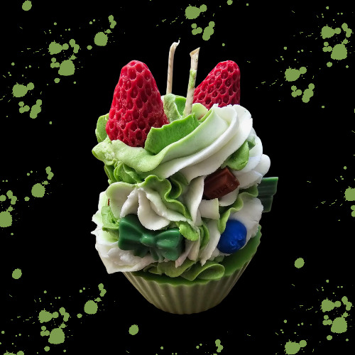 Green and white whip dessert candle with chocolate bar chunks and strawberry's on top.