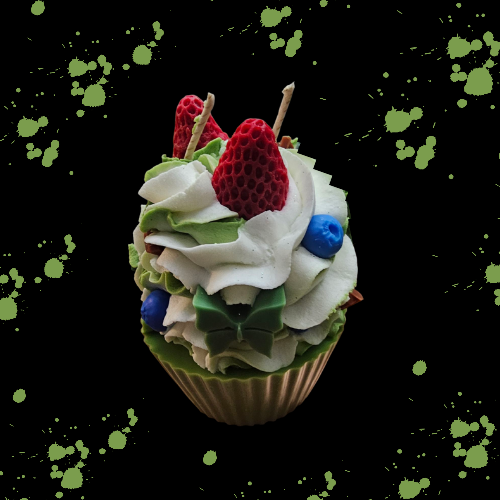 Green and white whip dessert candle with chocolate bar chunks and strawberry's on top.